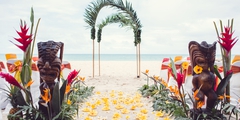 close up of a Hawaiian tiki for a beach wedding with Melanie