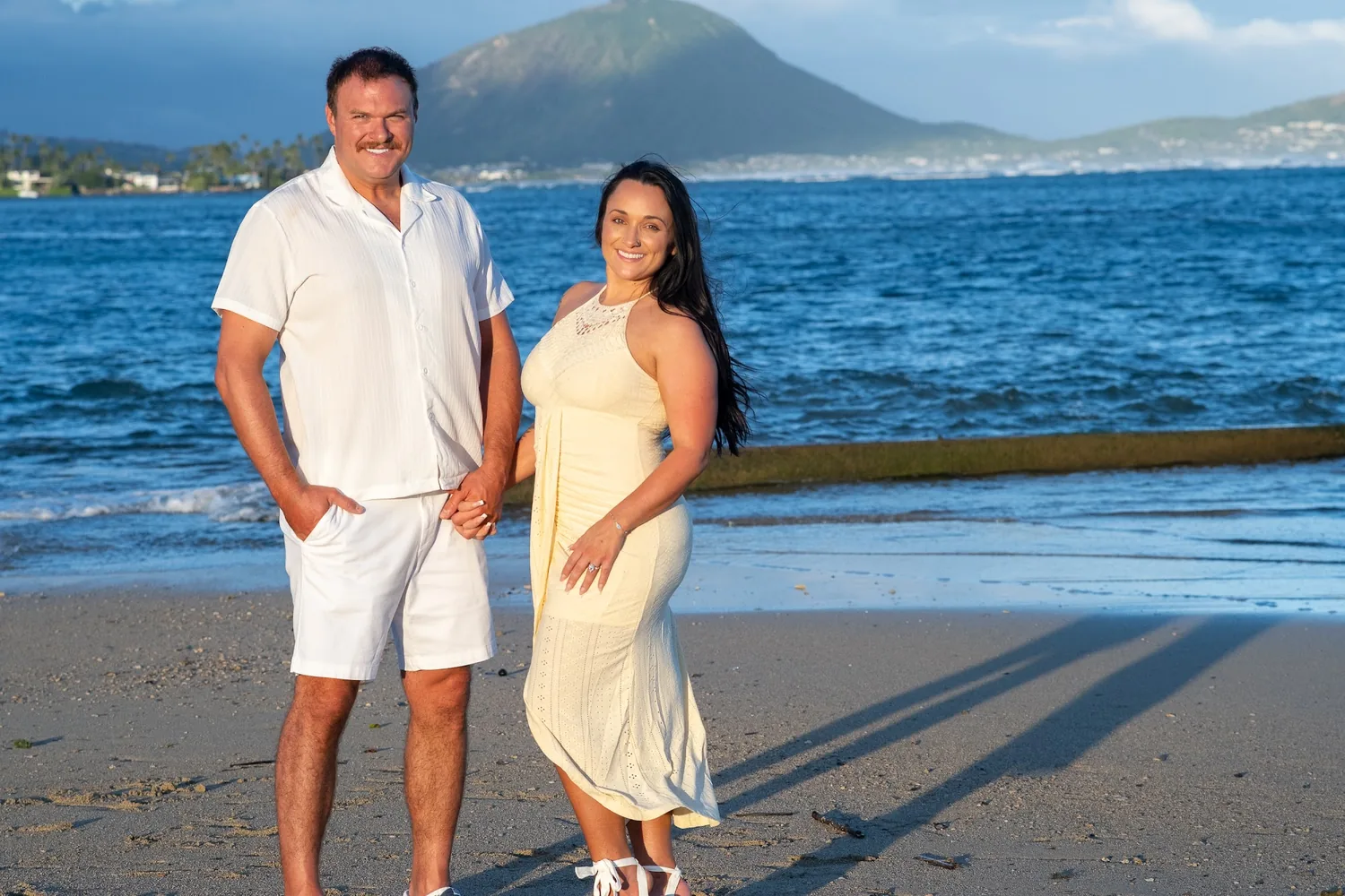 By the water with the mountains behind