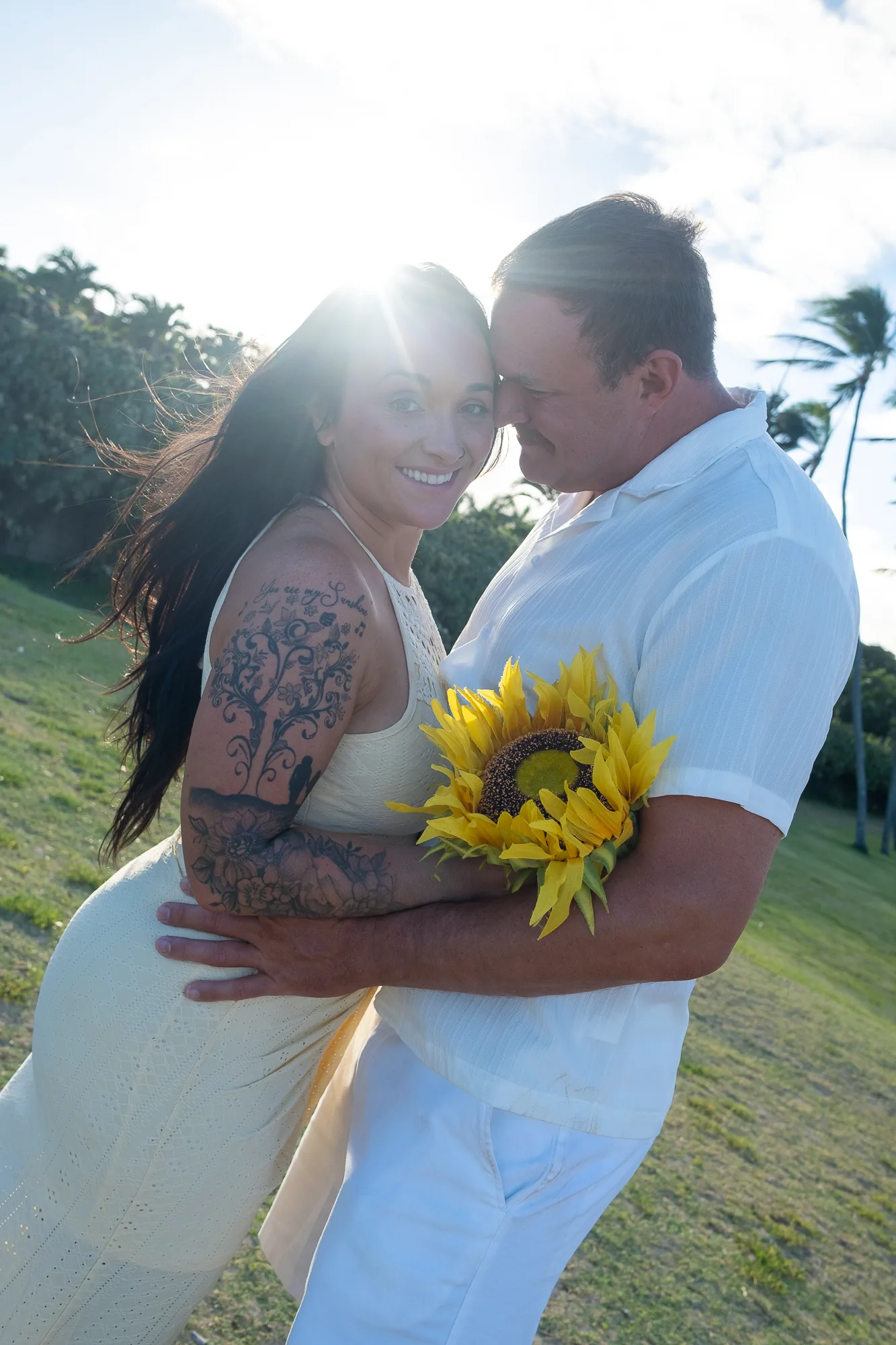 Forehead to forehead at sunset with a sunflower
