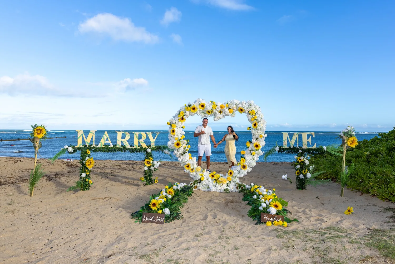 The flower heart and MARRY ME letters on the sand