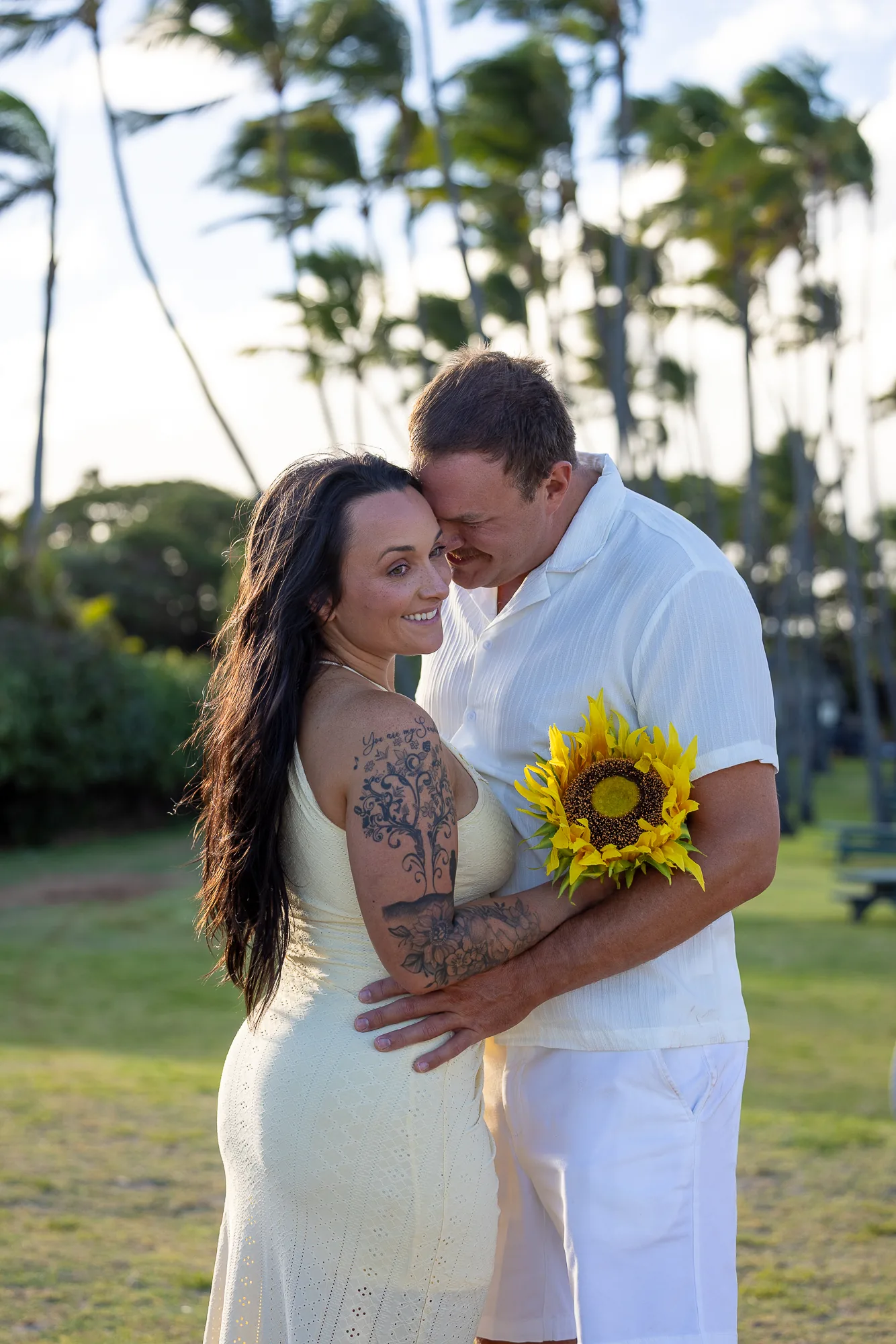 Makenzi holding a sunflower in Furman's arms