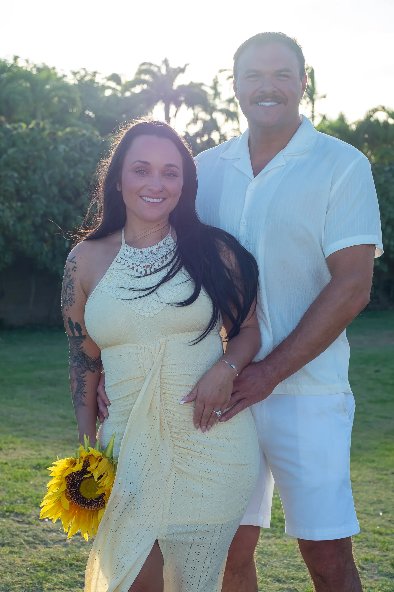 A portrait on the grass with the trees behind