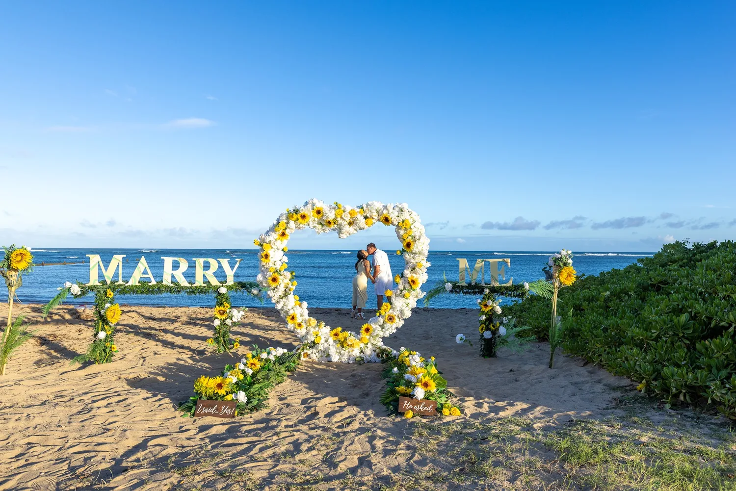 The flower heart and MARRY ME letters seen from down the beach