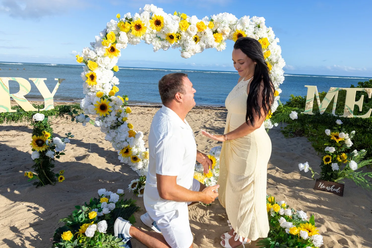 The proposal with the ocean behind them