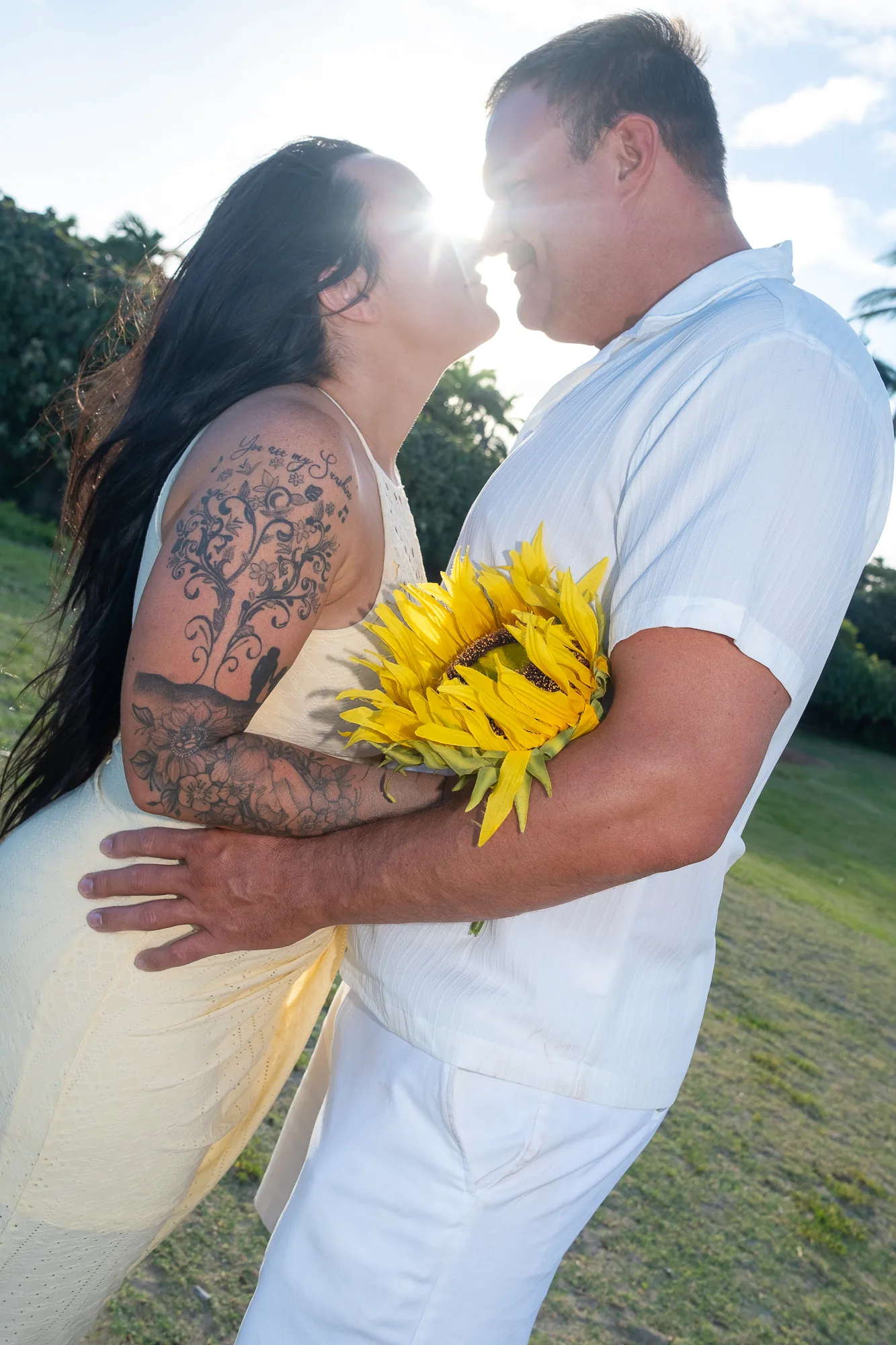 A hug with a sunflower at golden hour