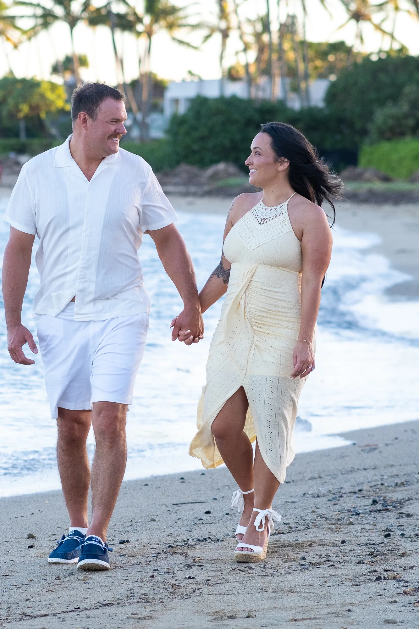 Walking hand in hand by the waves