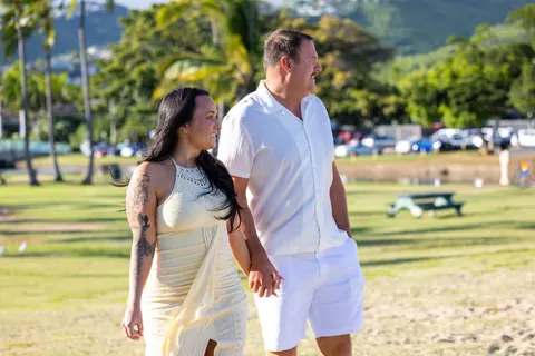 Smiling on their way to the beach under the palm trees