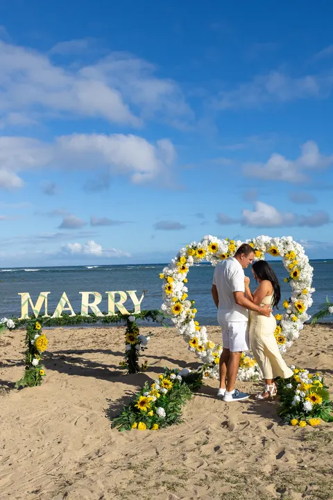 The sunflower and rose heart on Waialae Beach under a blue sky