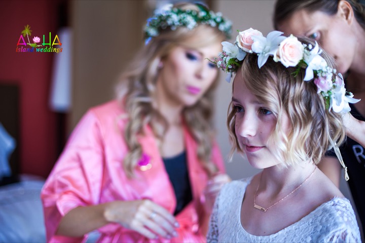 Flower girl wearing a haku lei at a Hawaii beach wedding