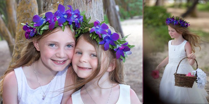 Two smiling sister flower girls in purple haku leis