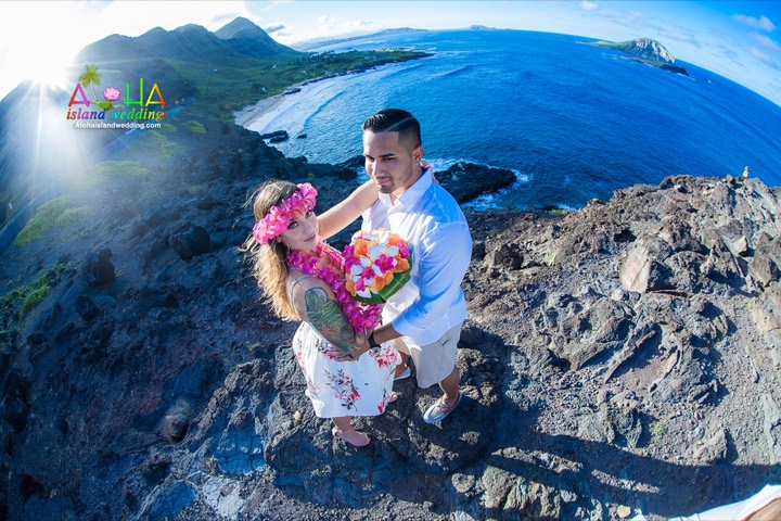 Pink plumeria haku lei on a bride above the cliffs of Makapuu