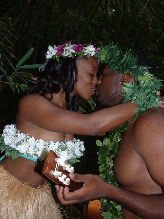 Naheshae in a flower head lei kissing her new husband in Honolulu
