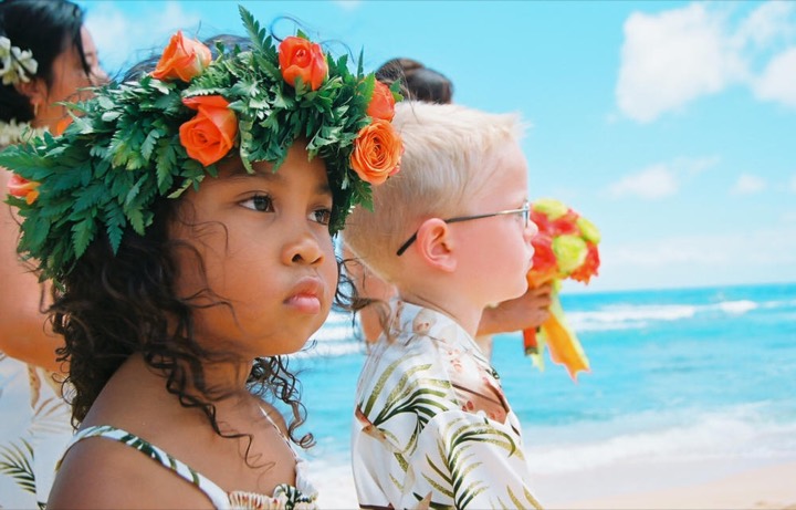 Flower girl in a haku lei of orange roses and Hawaiian fern