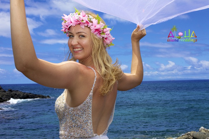 Bride in a crown of pink plumeria flowers at Makapuu Point, Oahu