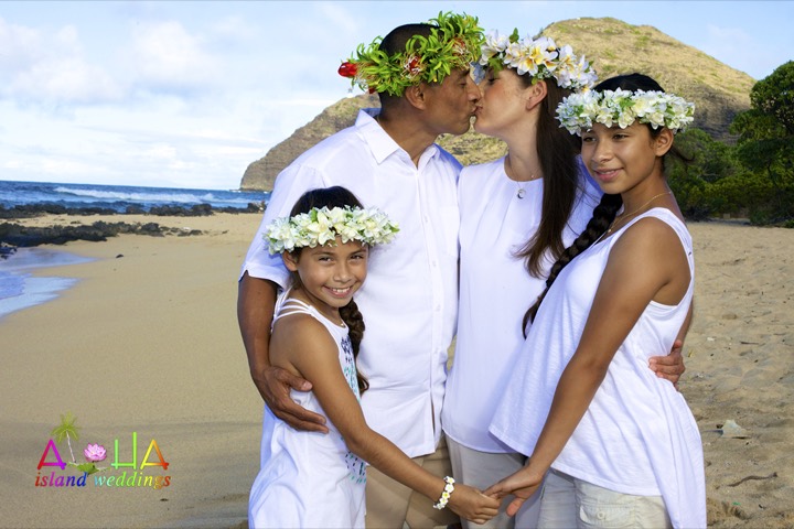 Children in white flower head leis at their parents' 8-year vow renewal