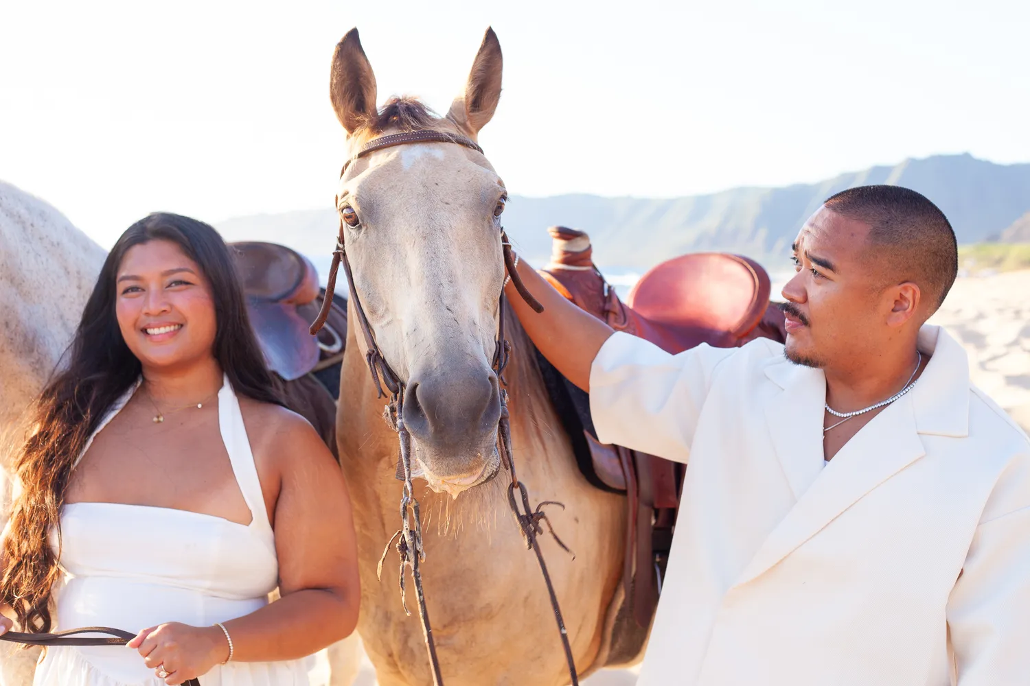 Petting the horses before the proposal, at a horseback proposal on Oahu