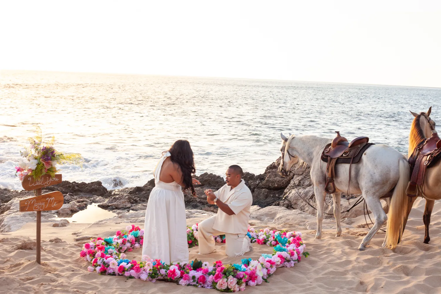 Proposal beside the horses at the flower heart, at a horseback proposal on Oahu