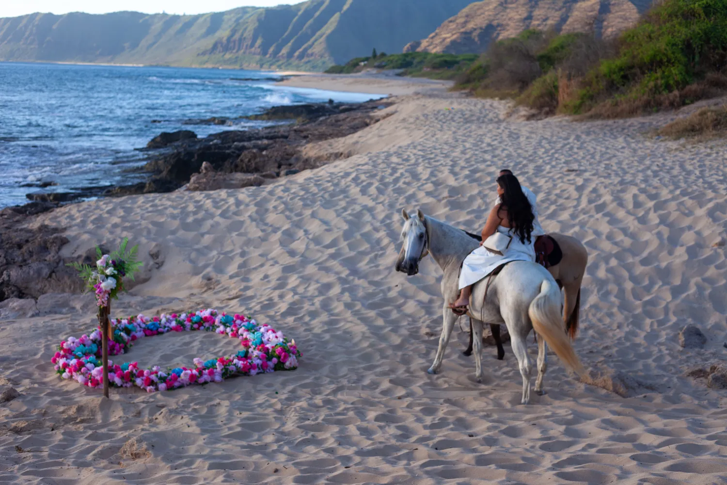 Riding horses along the oahu shoreline, at a horseback proposal on Oahu