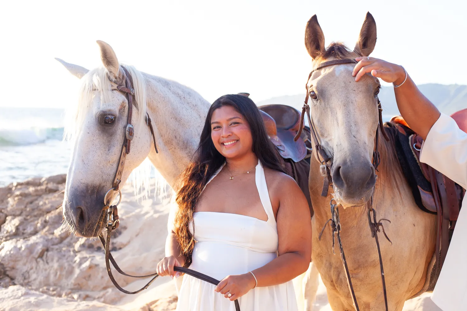 Smiling with the white horse, at a horseback proposal on Oahu