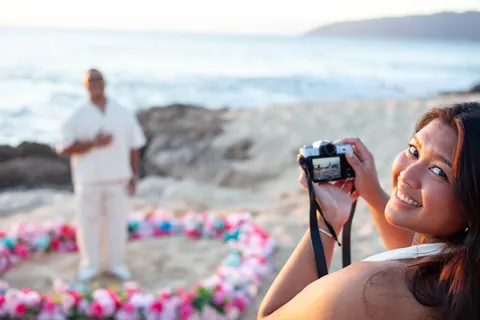 Bride to be taking a photo, at a horseback proposal on Oahu