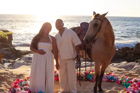 Couple beside the buckskin horse, at a horseback proposal on Oahu