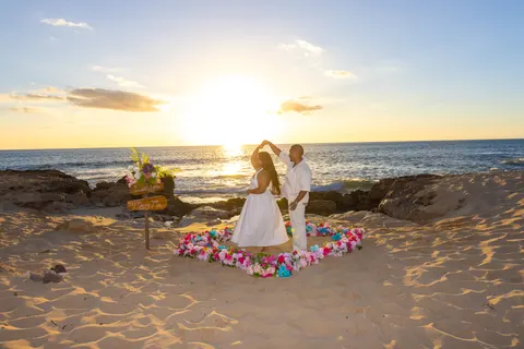 Couple in the flower heart as the sun sets, at a horseback proposal on Oahu
