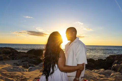 Couple smiling face to face at sunset, at a horseback proposal on Oahu