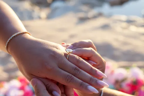 Engagement ring on her hand, at a horseback proposal on Oahu