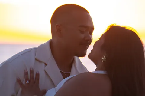 Golden hour kiss on the beach, at a horseback proposal on Oahu