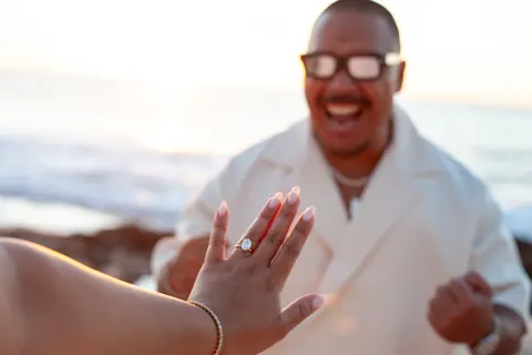 Groom to be laughing with joy, at a horseback proposal on Oahu