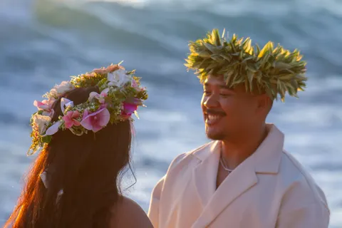 Haku leis and smiles by the ocean, at a horseback proposal on Oahu