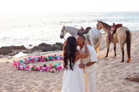 Kiss in front of the two horses, at a horseback proposal on Oahu