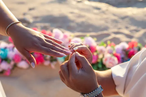 Sliding on the engagement ring, at a horseback proposal on Oahu