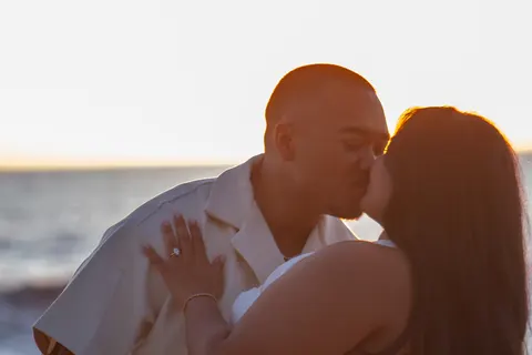 Sunset kiss with the engagement ring, at a horseback proposal on Oahu