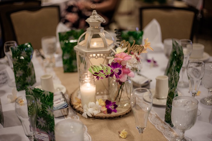candels white boho laterns with orchids for this table arrangement at Hale Koa