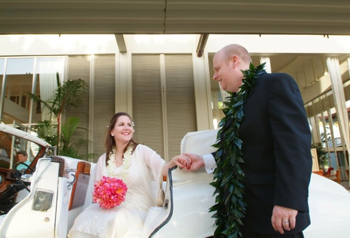 Bride and groom with a white Rolls Royce at the Kahala Resort Hotel