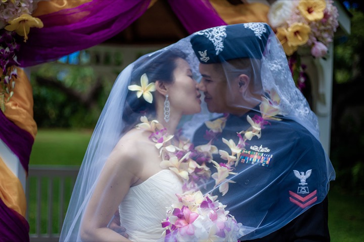 kissing under the viel after their ceremony with Reverent Chris Cain