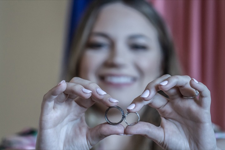 Lauren holding up the wedding rings while getting ready at the Hilton Hawaiian Village
