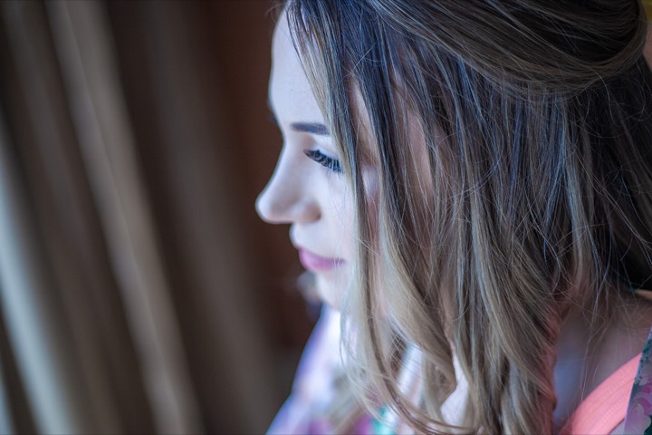 Lauren gazing out the window of her Hilton room on her wedding day