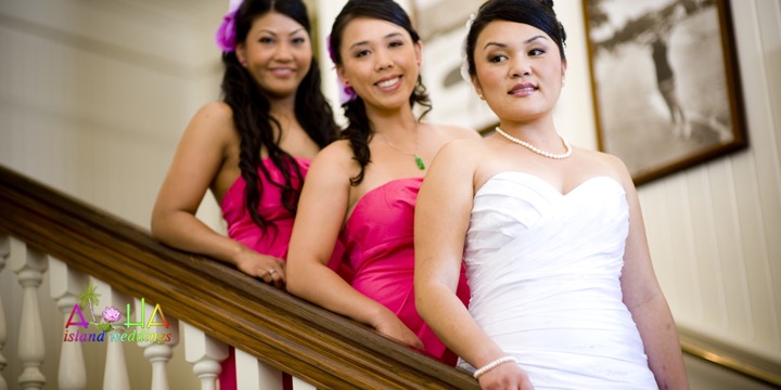 Bride and bridesmaids leaning on the staircase railing in the hotel