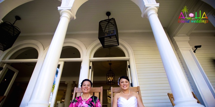 Bride and bridesmaids beneath the white columns of the Royal Hawaiian Hotel