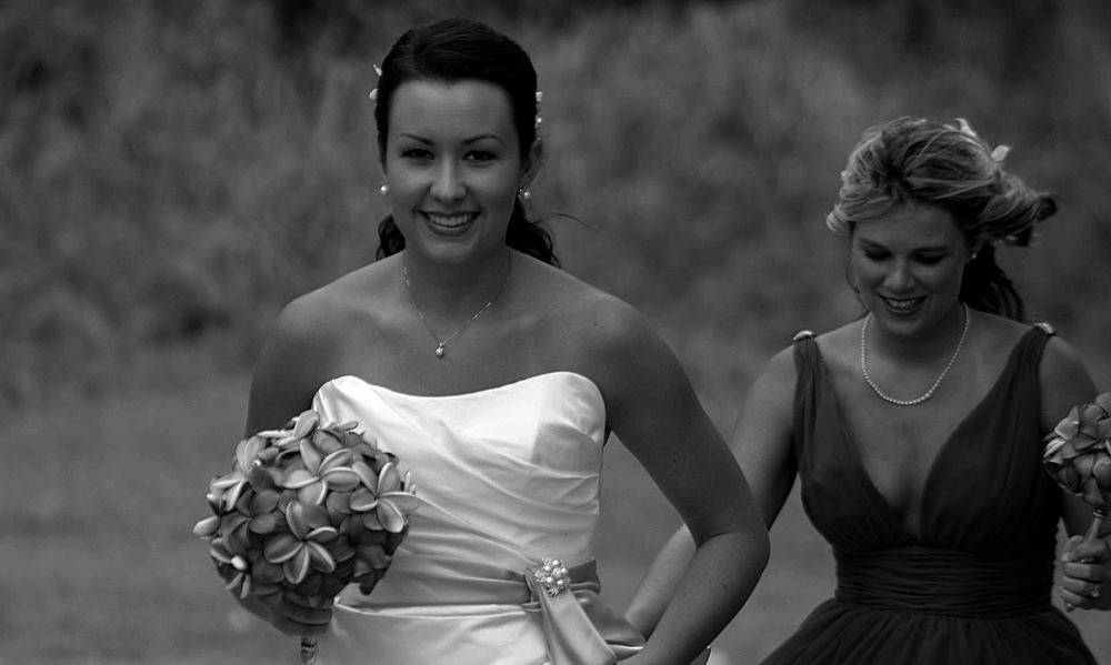 black and white photo of the bride walking to the alter on the beach in Hawaii