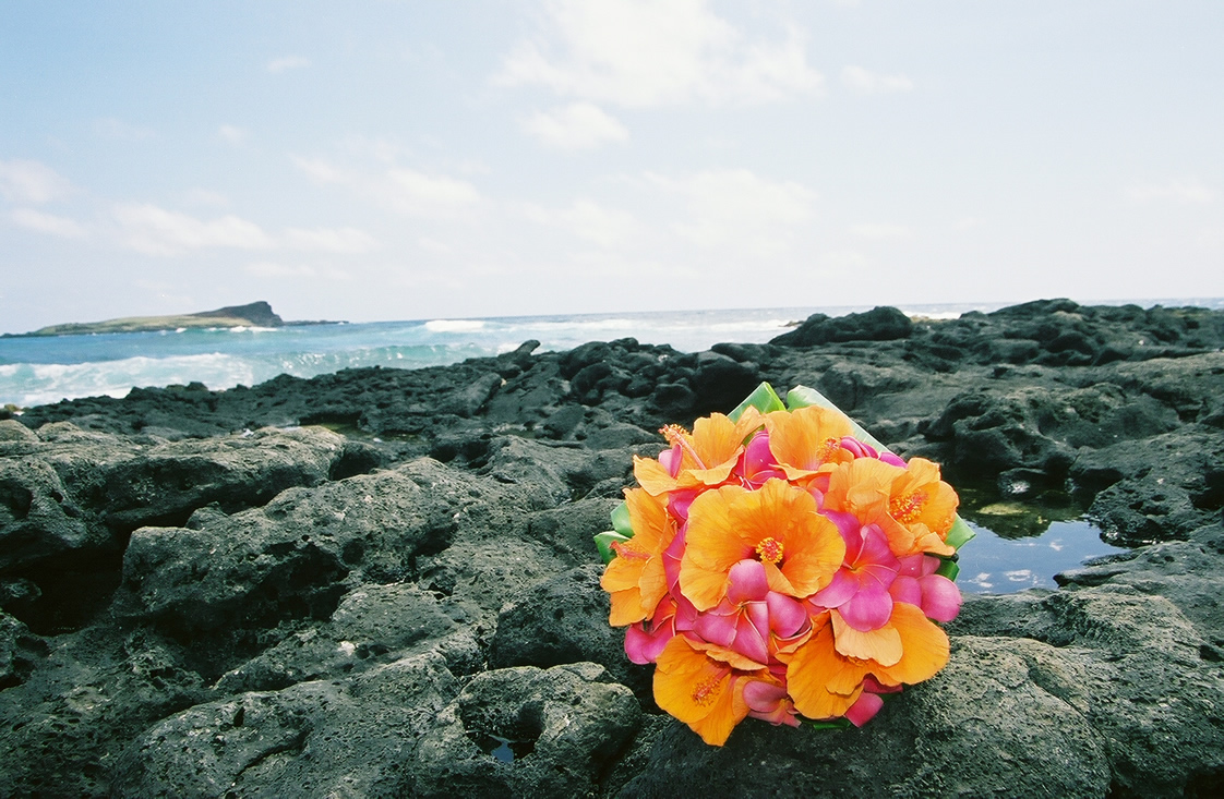 Orange and pink themed Hawaiian floral bouquet with orange hibiscus flowers