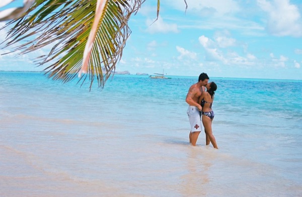 Jamillah and Brandon at Lanikai beach, in a playful moment