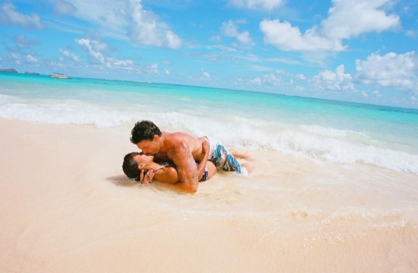 Jamillah and Brandon at Lanikai beach, in the bright sun