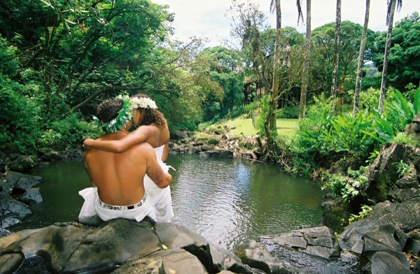 Jamillah deep in the jungle of Oahu, under a blue sky