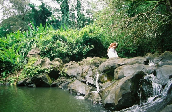 Jamillah deep in the jungle of Oahu, smiling