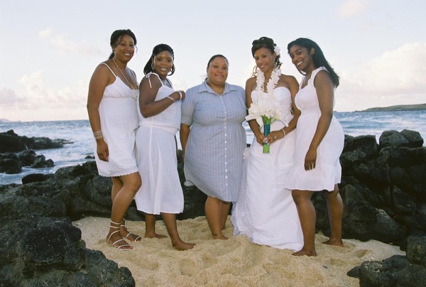 Family and friends with Jamillah on the beach, laughing together