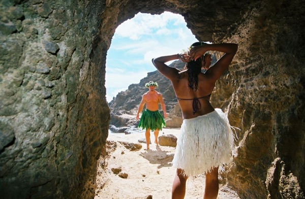 Jamillah and Brandon in a lava tube cave by the beach, on the sand