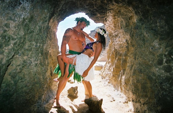 Jamillah and Brandon in a lava tube cave by the beach, close together